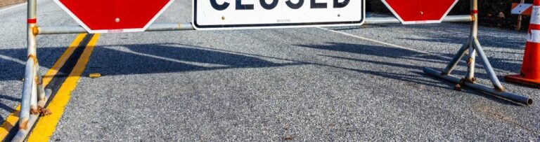 A road is closed sign blocking the way illustrating the concept of technical debt